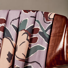 Load image into Gallery viewer, EcoVero Viscose fabric with large floral print, in soft pleated folds over the back of a wooden chair