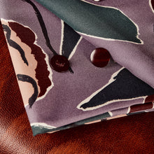 Load image into Gallery viewer, Folded pieces of EcoVero Viscose fabric with large floral print, shown with buttons on top