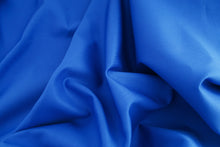 Load image into Gallery viewer, Close up of royal blue cotton drill fabric scrunched up.