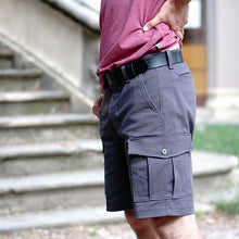 Load image into Gallery viewer, Side view of man wearing grey coloured cargo shorts with patch pocket with flap and button. Worn with a leather belt.
