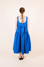 Load image into Gallery viewer, Back view of lady wearing Celestia dress shows low back neckline with tiered dress
