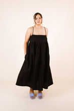 Load image into Gallery viewer, Lady stands with hands in pockets, wearing a Celestia tier dress with a drawstring square neckline