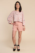 Load image into Gallery viewer, Lady stands wearing a boxy top with puff sleeve detail