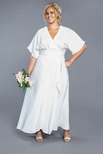Load image into Gallery viewer, Lady wears a short sleeve full length maxi Elodie Wrap Dress carrying a bouquet of flowers