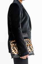 Load image into Gallery viewer, Side View of lady wearing a velvet Jasika Blazer holding a clutch bag