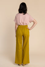 Load image into Gallery viewer, Back view of lady wearing Pietra Trousers with elasticated waist back