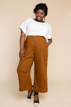 Load image into Gallery viewer, Lady wears a loose fitting pair of Pietra trousers with hand in pocket