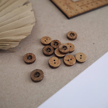 Load image into Gallery viewer, 12mm, 2-hole coconut buttons scattered across worktop