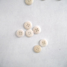 Load image into Gallery viewer, Top view of a group of natural Corozo buttons