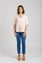 Load image into Gallery viewer, Lady wears Megan Nielsen Dove Blouse, a V-neck tunic blouse with short sleeves