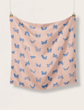 Load image into Gallery viewer, A square piece of Edmond EcoVero Viscose Twill fabric hangs on two suspended clips on top two corners. Fabric of various butterflies printed across.