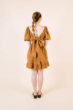 Load image into Gallery viewer, Back view of knee-length Estella Dress with cross over across back tied into big bow