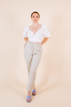 Load image into Gallery viewer, Lady wears a cross- over cropped top with puff sleeves