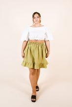 Load image into Gallery viewer, Lady wears a cropped top, with an elasticated waist, knee-length skirt with frill hem