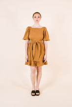 Load image into Gallery viewer, Front view of Estella dress with waist ties, and knee-length skirt with frill hem