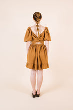 Load image into Gallery viewer, Back view of knee-length Estella Dress with cross over twist across back, cropped effect