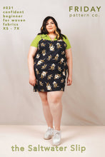 Load image into Gallery viewer, Lady stands wearing a Saltwater Slip Dress, above knee length, layered over a tee