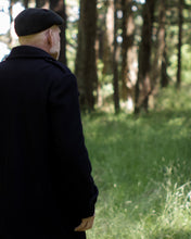 Load image into Gallery viewer, Back view of man wearing black peacoat shows off shoulder epaulettes.
