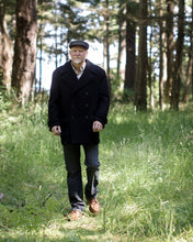 Load image into Gallery viewer, Full length view of man wearing black peacoat, worn fastened.