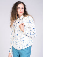 Load image into Gallery viewer, Lady wearing a blouse with cape detail at shoulders.