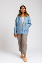 Load image into Gallery viewer, Lady wears a thin hip-length Hovea Jacket with deep slanted front pockets
