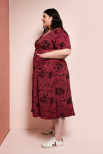 Load image into Gallery viewer, Side view shows lady wearing Hughes Dress with hands in pockets at hip level