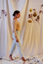 Load image into Gallery viewer, Side view of lady walking, wearing Hussard jeans showing pleating detail at waist.