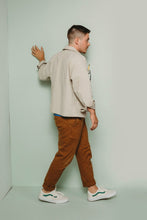 Load image into Gallery viewer, Male walks against a wall, showing back of hip length Ilford Jacket
