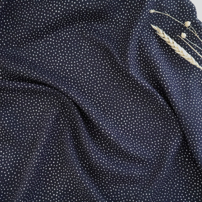 Viscose fabric with small dot print, slightly ruched shows drape