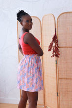 Load image into Gallery viewer, Lady wears a vest top paired with a short skirt made with the Nenuphar Viscose fabric