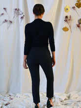 Load image into Gallery viewer, Back view of lady standing wearing smart fitted Loulou trousers with white piping at pocket seams, with hands by her side.