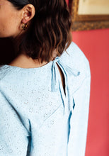 Load image into Gallery viewer, Back view of lady wearing a top with inverted box pleat into a yoke, open at centre-back, fastened with knotted ties