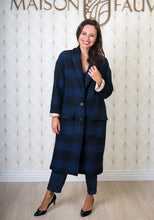 Load image into Gallery viewer, Lady wears a fastened maxi Pam coat with cuffs rolled up to reveal patterned lining fabric
