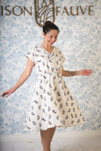 Load image into Gallery viewer, Lady twirls wearing Byzance Dress, v-neck, cap sleeves, knee length