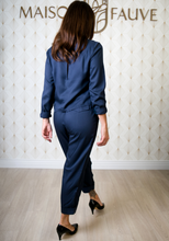 Load image into Gallery viewer, Back view of lady walking wearing the Faye Jumpsuit shows pocket flaps at back of trouser