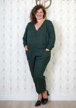 Load image into Gallery viewer, Lady wears Faye jumpsuit with no collar, V-neck. Hands in front trouser pockets