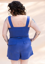Load image into Gallery viewer, Back view of lady wearing bustier and shorts jumpsuit. Shows pocket flaps on either side at back of shorts