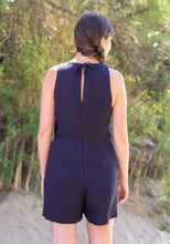 Load image into Gallery viewer, Back view of Luz jumpsuit shows invisible zip up to mid back, then the centre back at neck is fastened with a tie