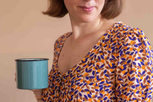Load image into Gallery viewer, Close up neckline of lady wears a wide V-neck dress made with Mandarine EcoVero fabric