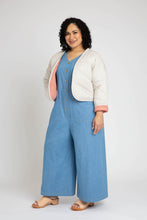 Load image into Gallery viewer, Lady wears a quilted cropped Hovea Jacket, showing the inside lining in contrasting fabric colour