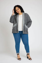 Load image into Gallery viewer, Lady stands wearing a quilted Hovea Jacket with hand in front slanted pocket