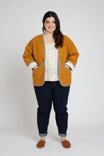 Load image into Gallery viewer, Lady stands wearing a quilted Hovea Jacket with hands in front slanted pockets