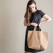 Load image into Gallery viewer, Lady holds bag wearing Camber Set T-Shirt Dress