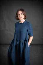 Load image into Gallery viewer, Front view of lady wearing Ellis Dress with hands in side pockets