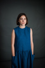 Load image into Gallery viewer, Lady wears sleeveless Hattie Dress with hands in pockets