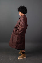 Load image into Gallery viewer, Side view of lady wearing duster overcoat with hands in pockets