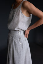 Load image into Gallery viewer, Close up detail of button fastening at side seam above pocket.