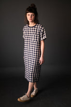 Load image into Gallery viewer, Lady wears a long tee-shirt dress with chest patch pocket in a check pattern