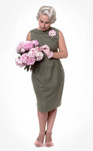 Load image into Gallery viewer, Front view of lady wearing sleeveless green dress with wide neckline, pencil skirt, tucks at waistline, slim belt. Skirt below knee length.