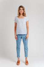 Load image into Gallery viewer, Lady stands wearing Olive Blouse, a short sleeve top with V-neck insert and breast patch pocket